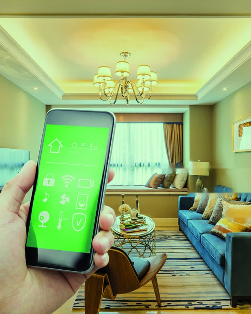 A hand holding a phone with a smart-home control app in a living room, from the You & Me smart-home brochure