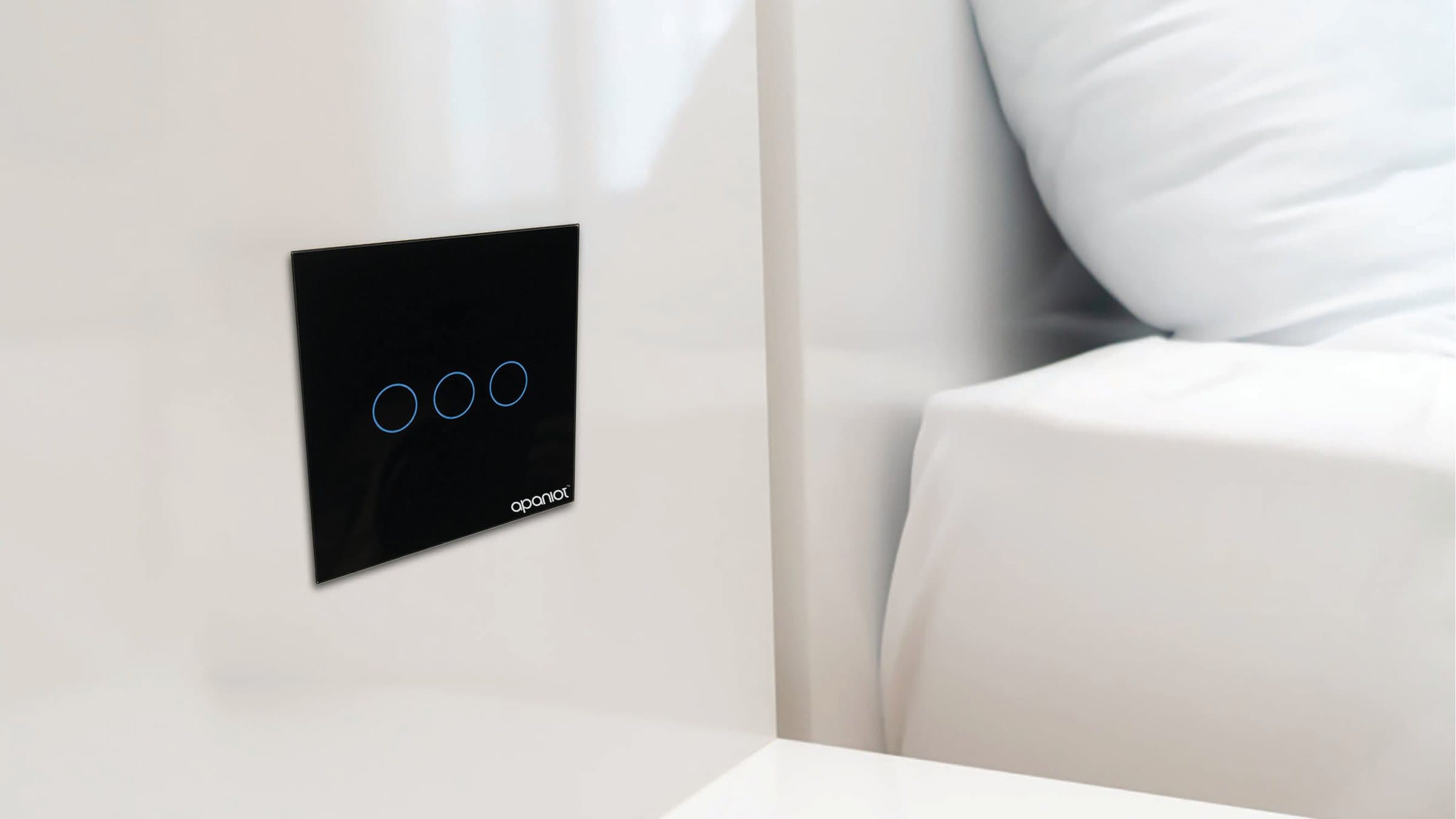 Apaniot CH-A3 black glass touch switch installed on a white wall beside a bed