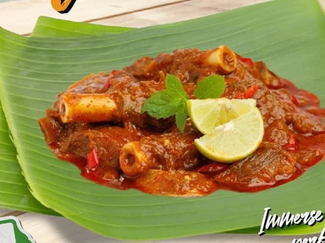 Mutton masala served on a banana leaf